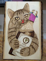 Woodburning cat with bottle
